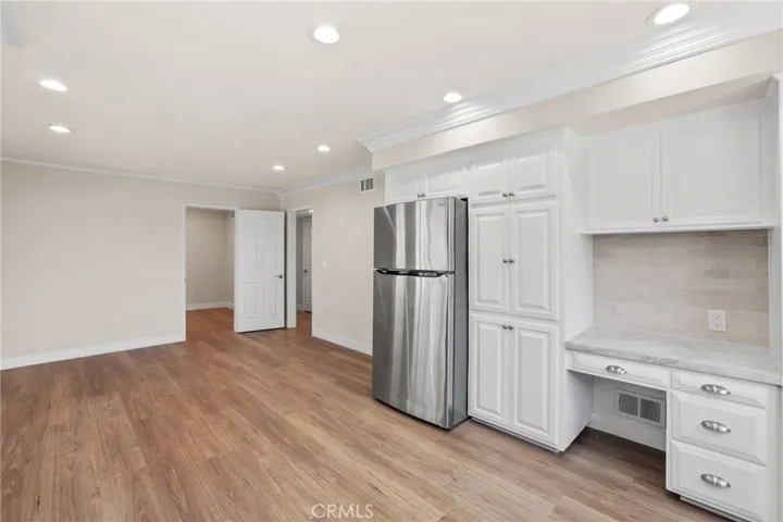 View of office door and hallway entry from kitchen