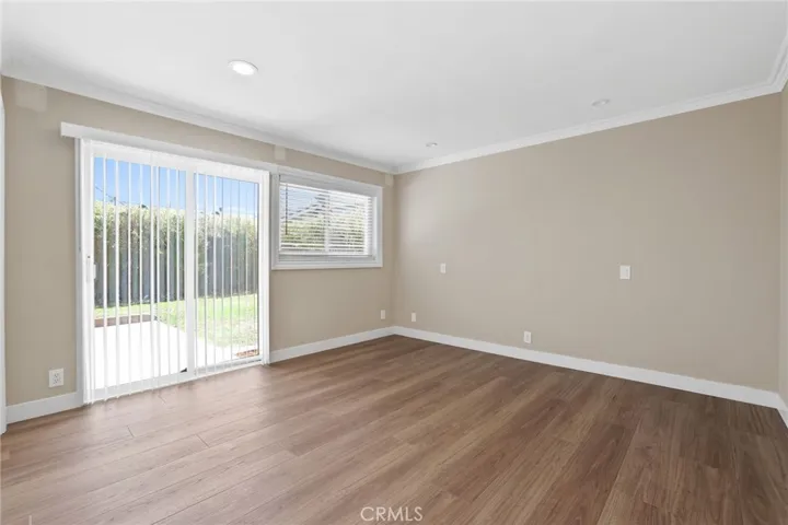 Primary bedroom has sliding glass door access to the backyard and recessed lighting.