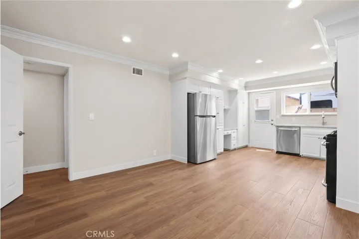 View of dining area, kitchen and hallway entry to bedrooms