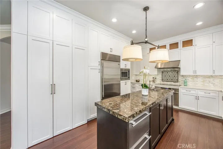 Floor-to-ceiling pantry cabinetry provides exceptional storage