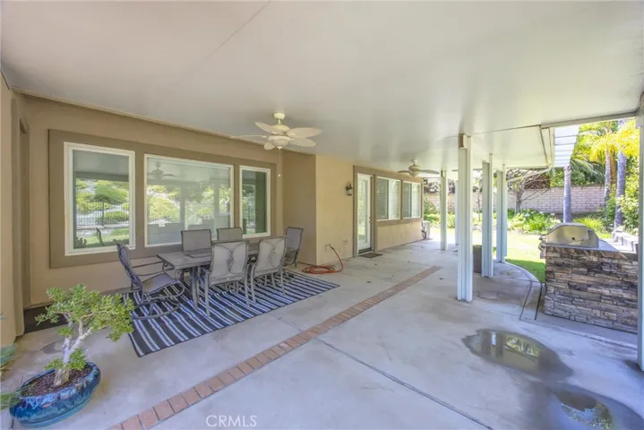 Covered patio with built-in BBQ island and ample space for outdoor entertaining