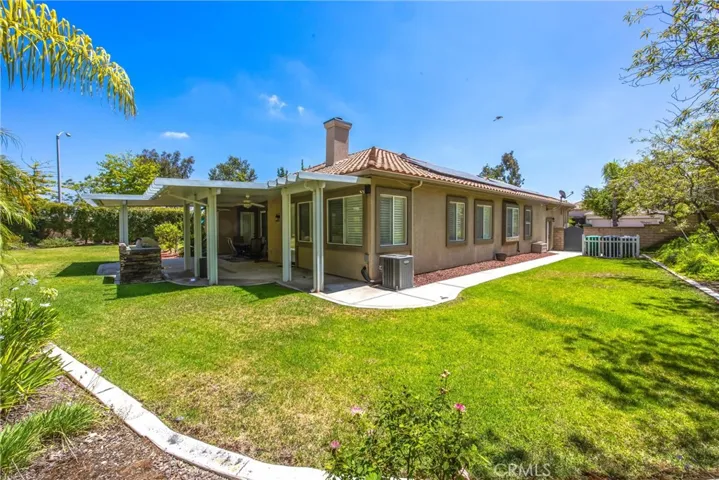 Expansive backyard with a covered patio and spacious lawn