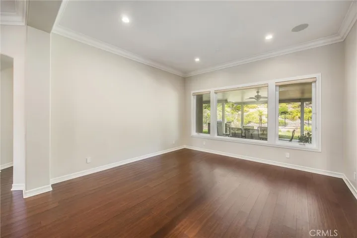 Spacious living room with expansive windows overlooking the backyard