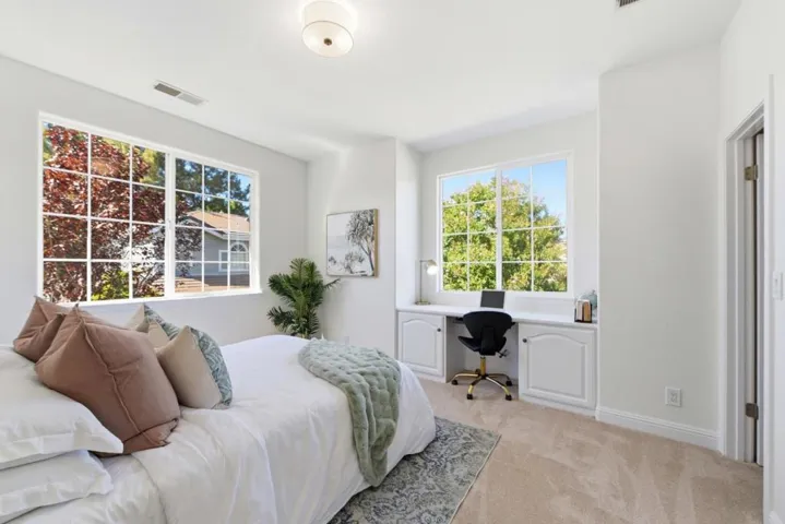 Bedroom at the back of the house, walk in closet and build in desk. New carpet, new paint and light.