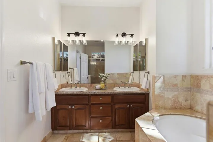 Primary suite with dual sinks, jetted tub and shower.