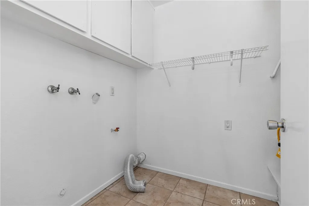 Laundry room with washer & dryer hookups and storage