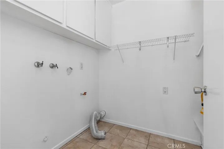 Laundry room with washer & dryer hookups and storage