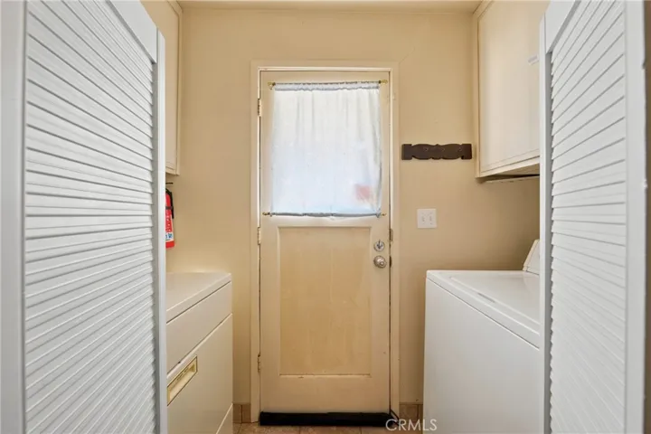 laundry off kitchen and door to back deck