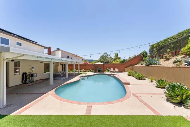 Easy maintenance large backyard with heated pool & spa