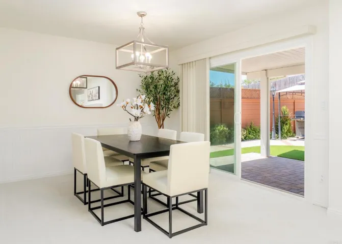 To the side of the kitchen, and opens up to the backyard/covered patio
