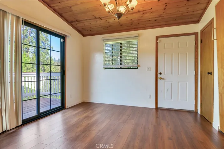 Bedroom with fold-down bed, exterior access with stairs to parking deck and slider access to large top deck