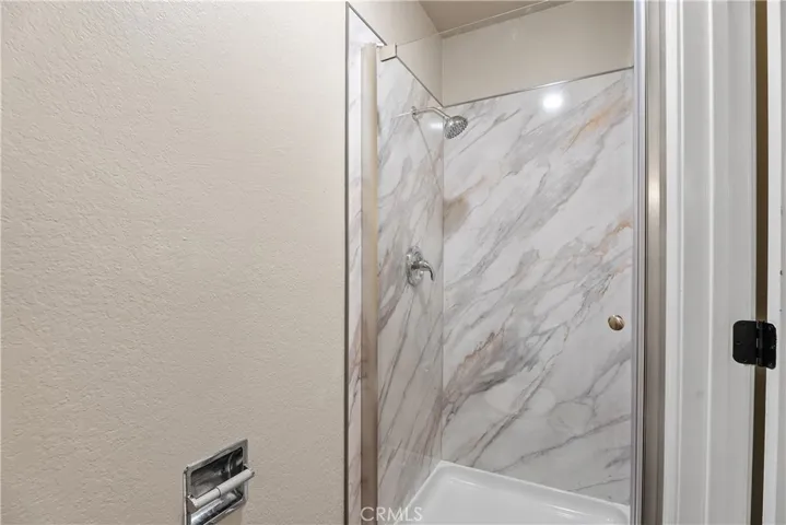 Primary bath with a brand new shower enclosure and fixtures