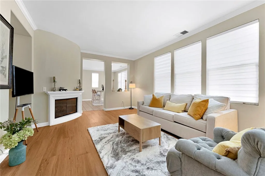 Bright and inviting living room with crown molding throughout the home