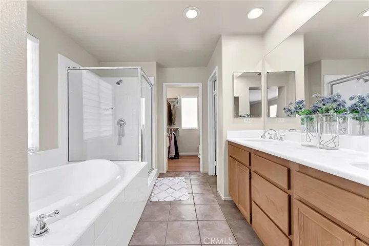 Primary suite with tub and shower , dual sinks and large walk-in closet