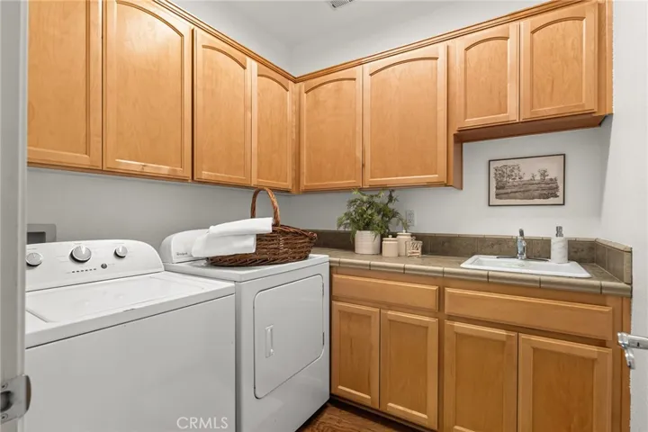Just off the kitchen is a spacious Laundry Room with sink! Washer / Dryer included