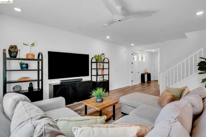 Bright living space featuring wood-finish flooring and recessed lighting