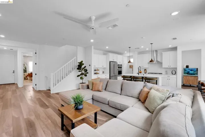 Open-concept living area with light wood-finish flooring