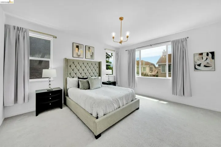 Bright room with light-toned wall finishes and neutral carpeting