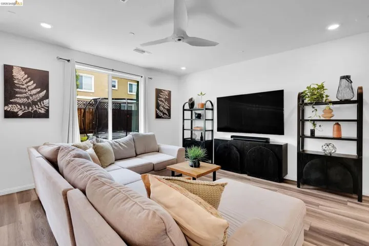Light wood-finish flooring complements the bright white walls and recessed lighting