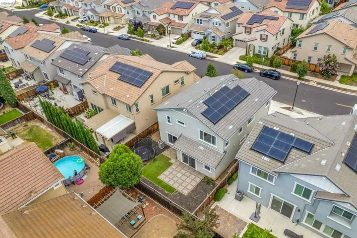 Aerial view showcasing a residential street lined with multi-story homes