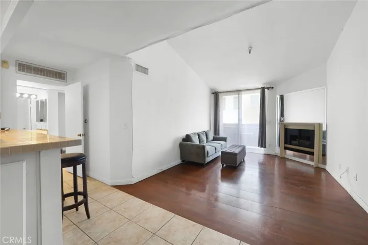 Living room w/high ceiling, fireplace & balcony