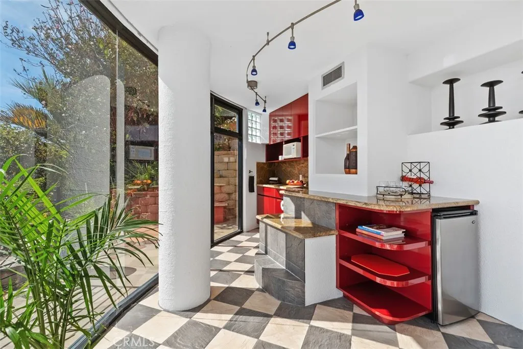 Kitchenette in guest quarters has small electric cooktop, microwave, mini-frig, cabinet storage and sink area.