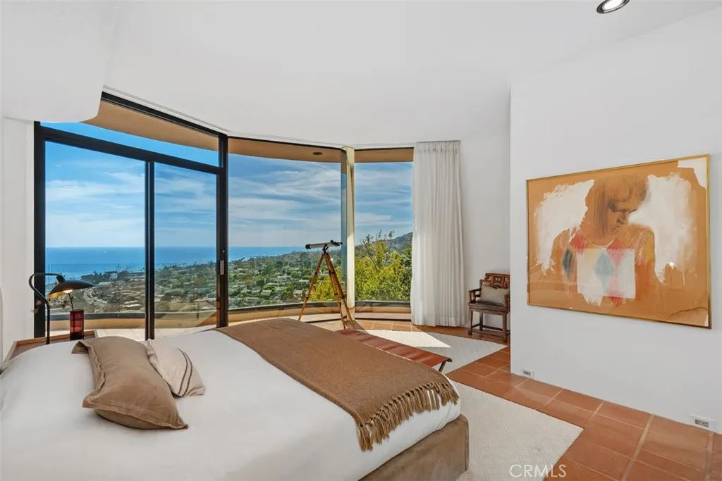 Primary bedroom on top level has access to deck and views to enjoy day and night.
