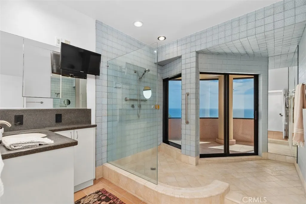 Second level bathroom has large shower and slider to outside.