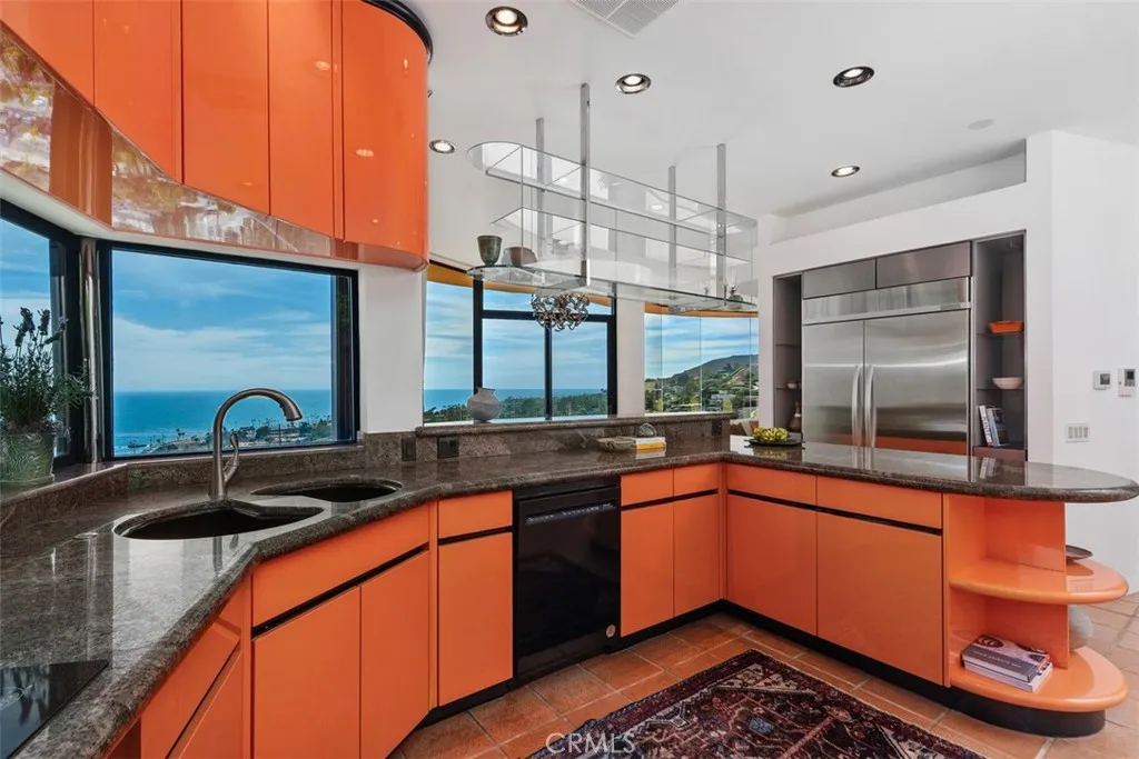 Kitchen is colorful and practical, many laminate cabinets most with built-ins and pull-outs.