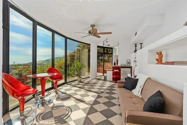 Third level guest quarters has living room with walls of glass to enjoy the views, mini refrigerator, kitchenette.