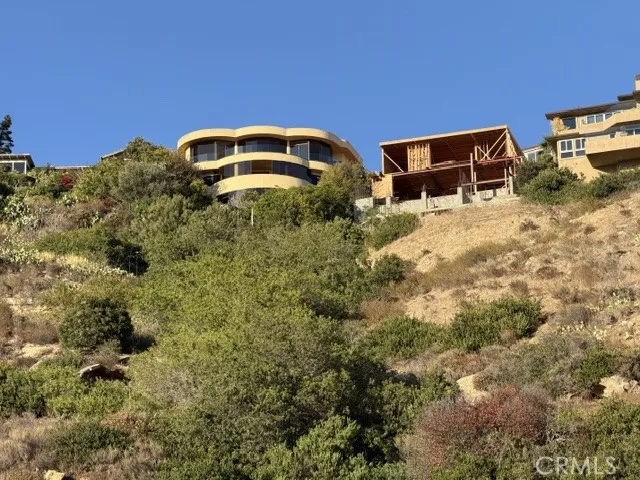 Distinctive design has been admired for decades, new construction next door on what was a lot where former home burned in 1993 fire.