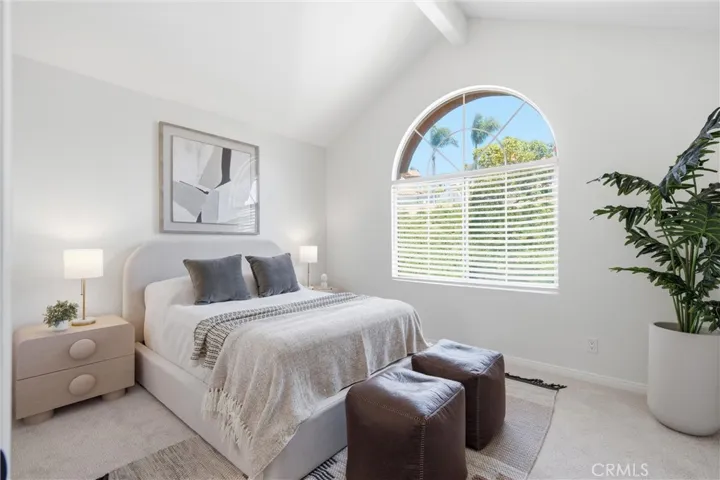 Spacious secondary bedroom highlighted by vaulted ceilings and abundant natural light