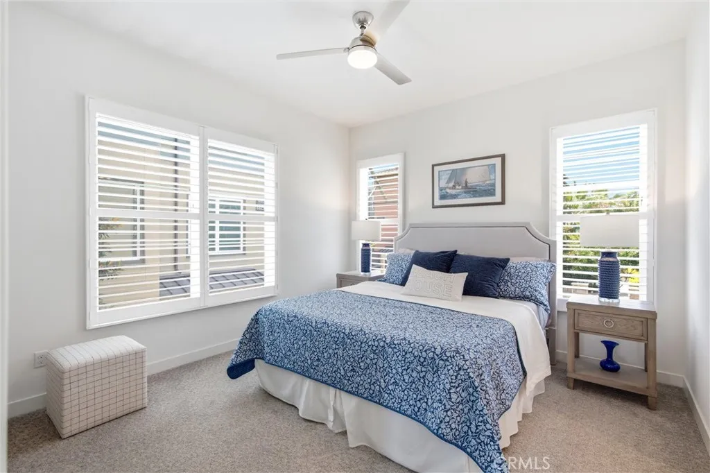 pacious primary suite with plantation shutters and abundant natural light. direct access to the spa-inspired bath.