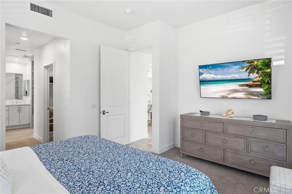Primary suite offering a peaceful retreat with direct access to the spa-inspired bath.