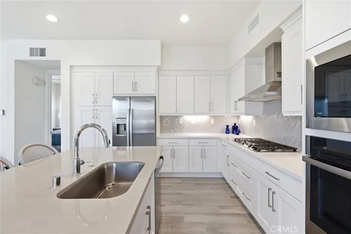 Designer kitchen featuring quartz countertops, herringbone backsplash, and premium appliances.