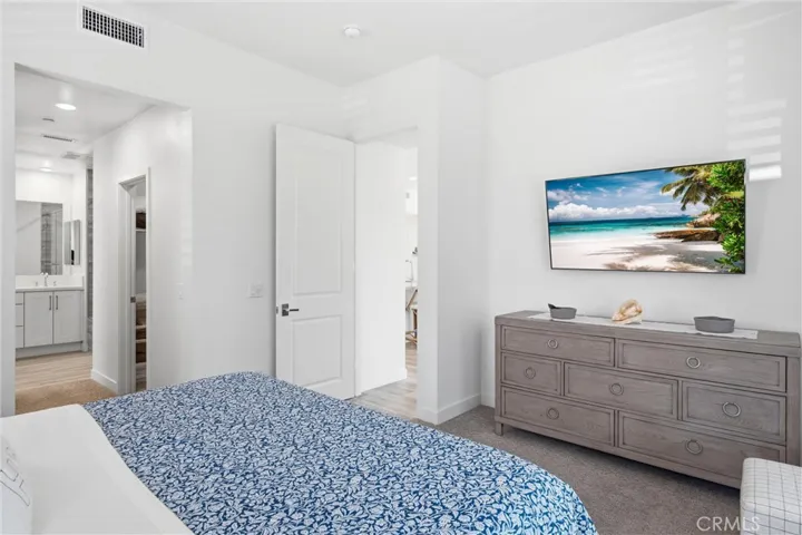 Primary suite offering a peaceful retreat with direct access to the spa-inspired bath.
