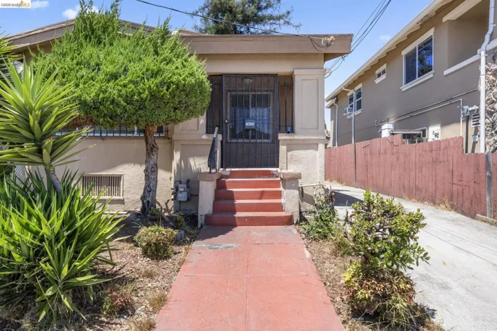 Stucco exterior with a covered porch entry
