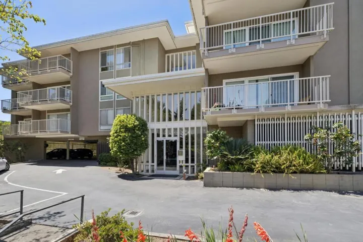 Front of 1101 Continentals Way. Nestled among mature trees & located in Belmont's rolling hills.
