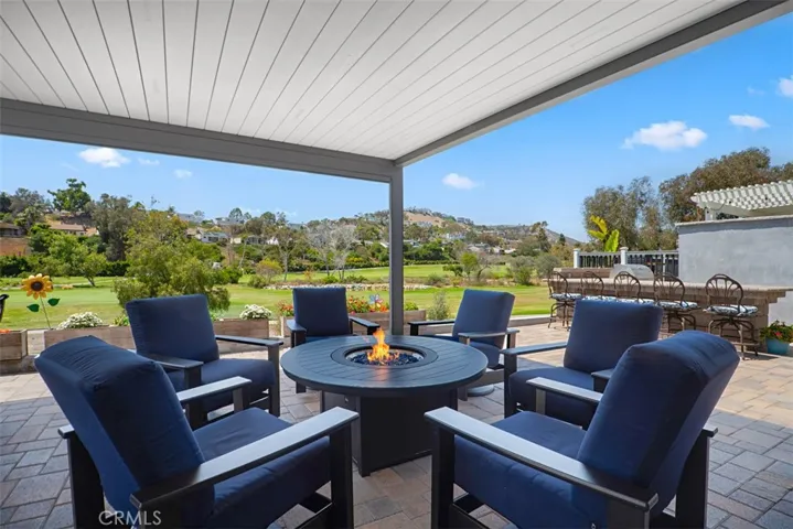 Relax beneath the covered patio while taking in panoramic golf course views, an incredible setting for morning coffee, evening conversations, or simply enjoying the peaceful surroundings.