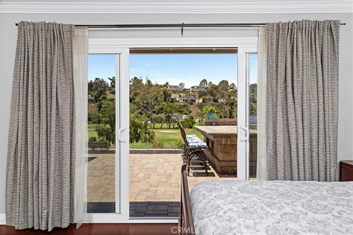 Enjoy tranquil golf course views from the comfort of your bed, with direct access to the expansive outdoor living space.