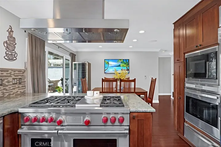 A spacious center cooking station with Wolf dual-fuel professional range creates the perfect workspace for preparing meals and gathering with family and friends.