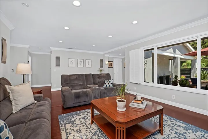 Comfortable living room filled with natural light and oversized windows.