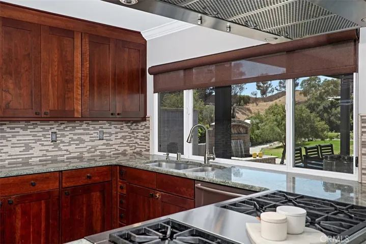 Enjoy golf course views from the kitchen, where expansive counters and abundant workspace for everyday cooking.