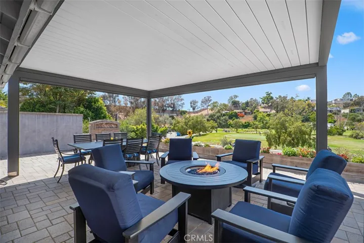 The custom motorized pergola transforms the patio into an exceptional outdoor retreat with adjustable louvers, integrated lighting, and retractable remote-controlled screens, allowing you to enjoy the golf course views in comfort from morning coffee to evening gatherings.