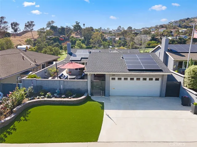 Gorgeous curb appeal, paid solar, turf, and an oversized driveway.