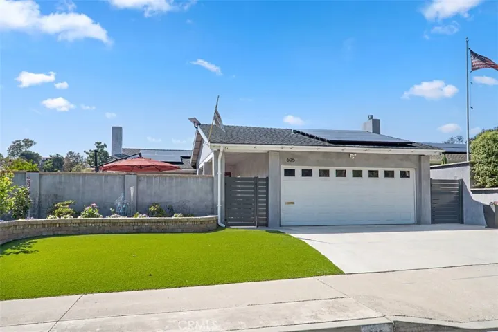 Beautiful curb appeal with fresh landscaping, paid solar, an attached two-car garage, and a gated front courtyard that adds both privacy and charm.