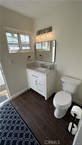 Bathroom with door to sideyard, laundry.