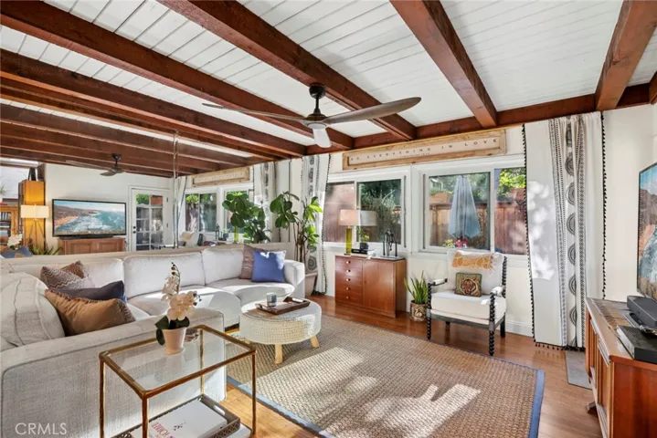 Rich wood beam ceilings and a wall of windows fill the great room with natural light