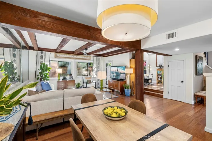 Dining area overlooks the great room beneath dramatic exposed beam ceilings.