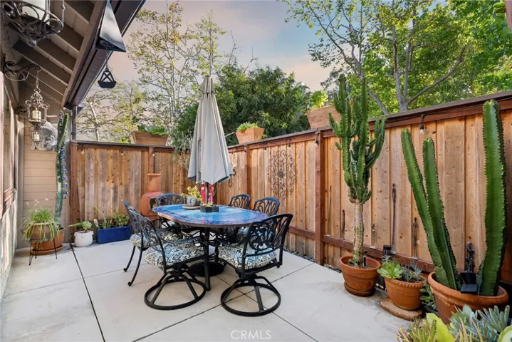 The private patio extends your living space outdoors, offering plenty of room for dining, entertaining, weekend barbecues, or relaxing under a canopy of mature trees.